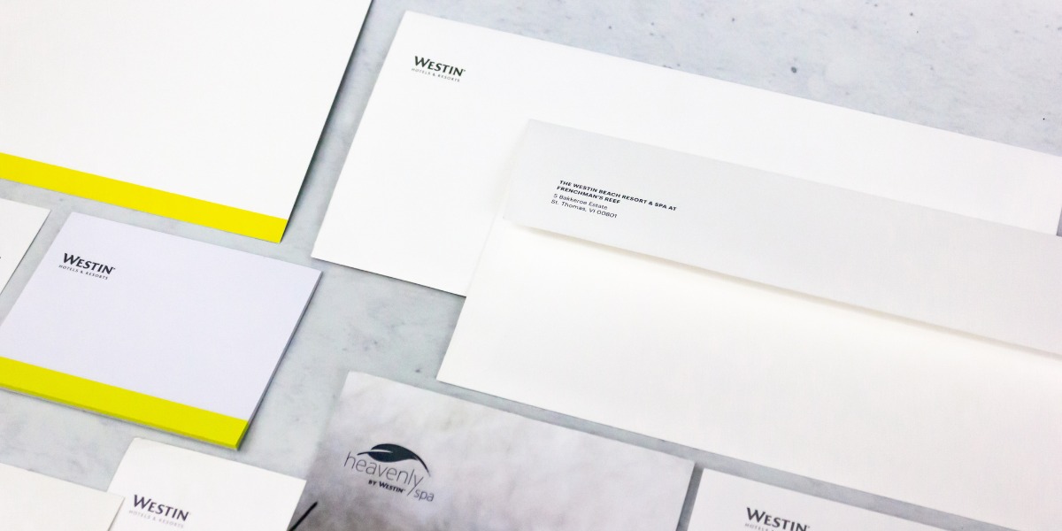 Imagen de papelería corporativa para Westin Hotels & Resorts, con sobres, cartas y libretas en diseño minimalista blanco con detalle amarillo, mostrando impresión premium para hoteles en Cancún realizada por Grupo Regio.